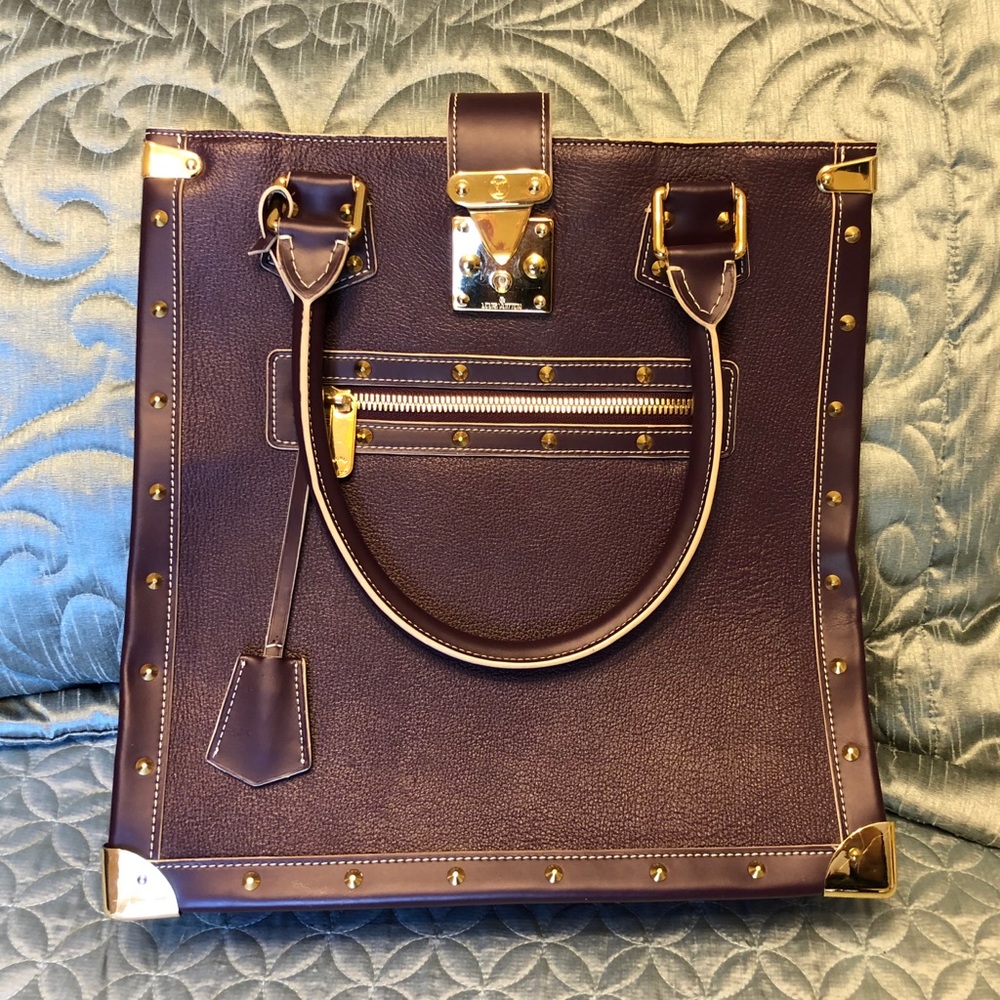 Louis Vuitton purple bag.